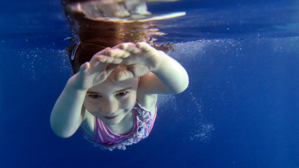 happy girl having swimming lessons