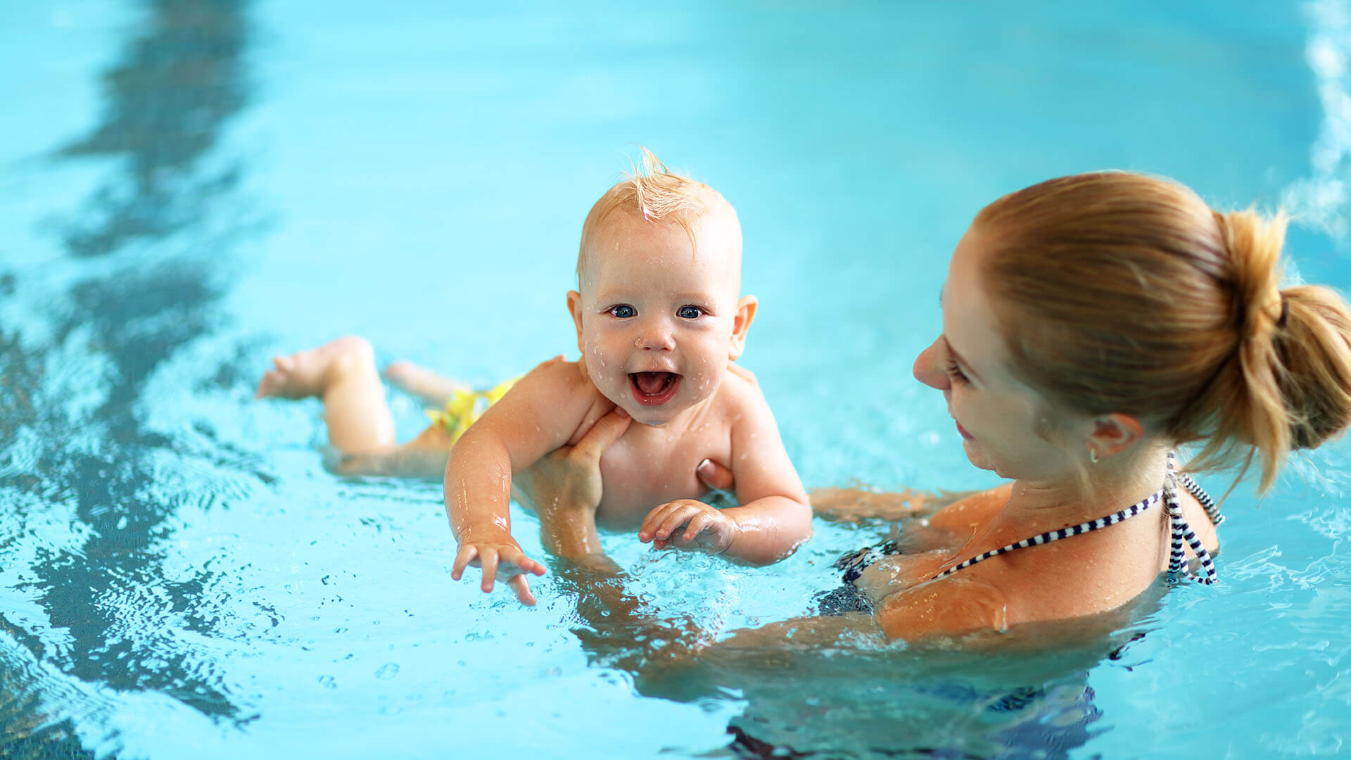 stock image of parent and baby swimming lesson programmes
