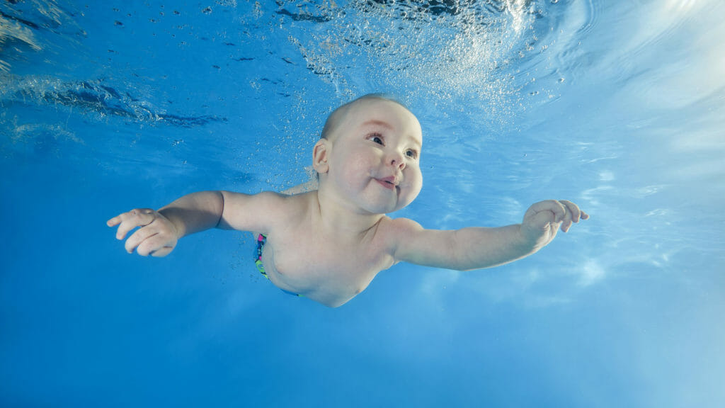 baby confidently swimming underwater